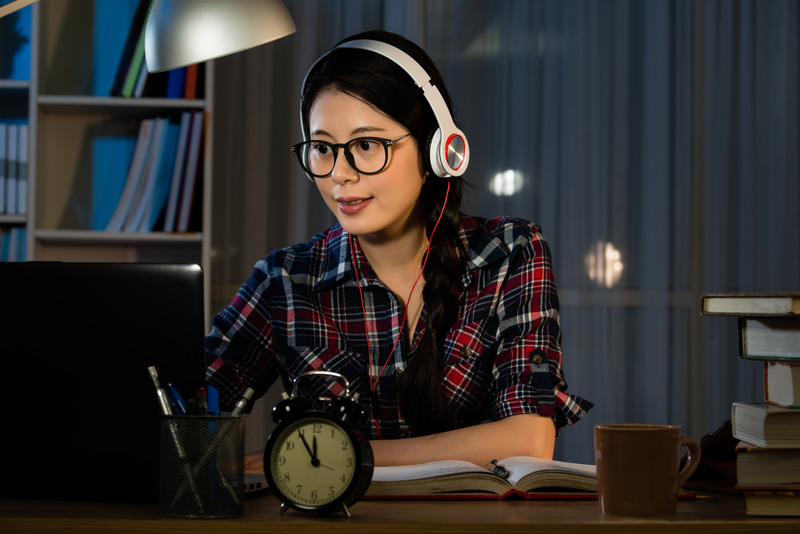 Hipster student studying and listening