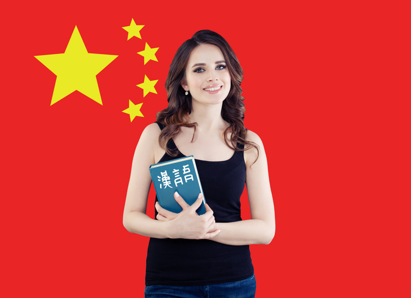 Speak chinese concept. Happy woman against the People’s Republic of China flag background