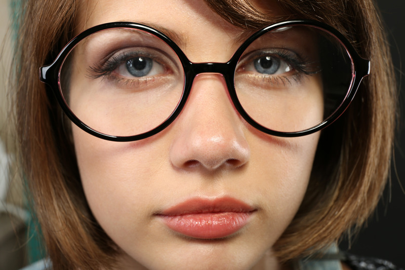 Attractive young woman with glasses close up